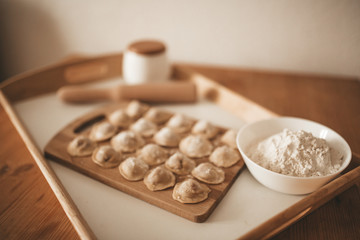 Raw dumpling with meat. Preparation dumplings on a wooden board.