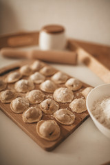 Raw dumpling with meat. Preparation dumplings on a wooden board.