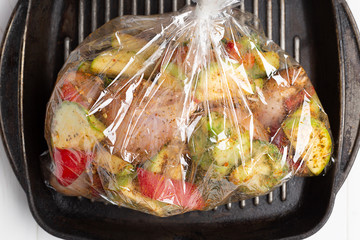 Unbaked vegetables in the oven baking bag. Cooking dishes. top view