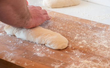 Man kneading homemade bread dough