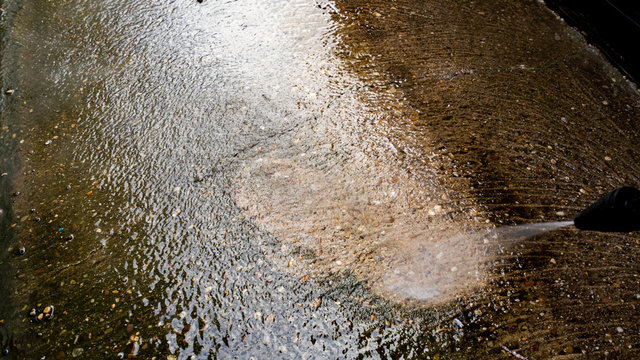 Jetwashing a dirty concrete path or patio