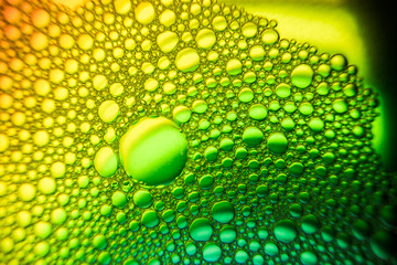 Close up of the Colorful bubbles on a green, yellow, red background.