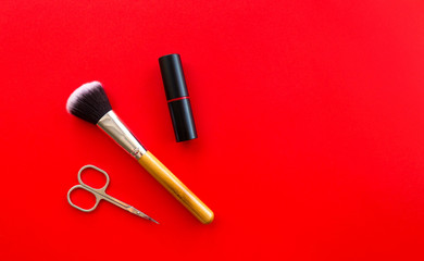 Set of professional decorative cosmetics, makeup tools and accessory on red background. Beauty, fashion and shopping concept. flat lay composition, top view