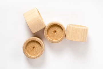 wooden puzzle on a white background, wooden cylinder, children's environmentally friendly toys for children, the development of fine motor skills and thinking in children