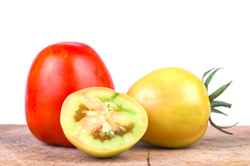 Naklejka na ściany i meble Fresh tomatoes on a wooden floor with a white background