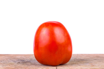 Fresh tomato on a wooden floor with a white background