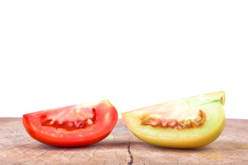 Fresh tomato on a wooden floor with a white background