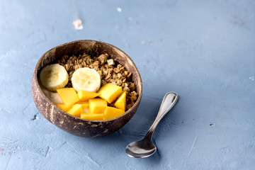 Granola With Yogurt Banana and Mango Tasty Healthy or Diet Breakfast Horizontal Copy Space Coconut Bowls Blue Background