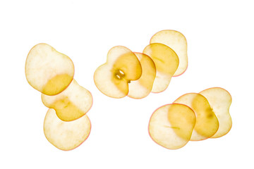 Apple slices photographed in transparency. Minimalist composition on white background.