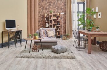 Decorative brown interior room, wooden bookcase background, grey armchair, coffee table and parquet detail.