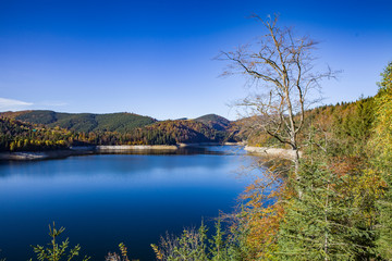 Beautiful aerial view of a blue lake in the mountains in autumn. 