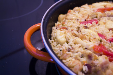 Rice paella cooked with chicken, seafood and vegetables