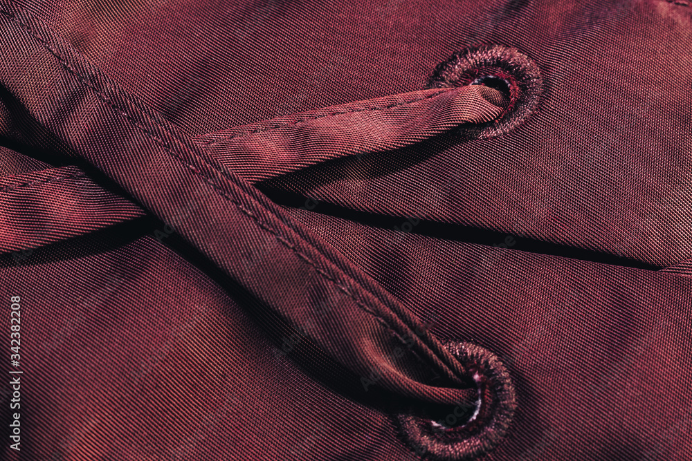 Poster close up beautiful red textile cloth background with stitching. macro photography background materia