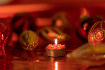 Christmas still life with red baubles and candle