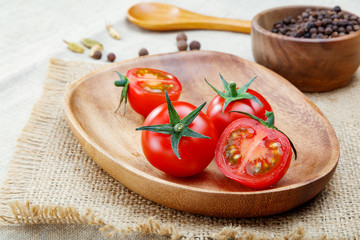 red tomatoes in wooden plate