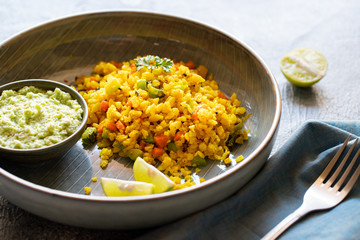 Indian cuisine Indian food. Indian cuisine. Poha or flattened rice traditional Western Indian breakfast with coconut chutney sauce curry leaves. national authentic vegetarian Asian food.