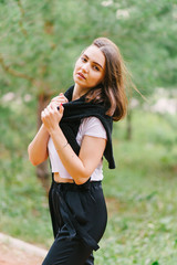 Fototapeta premium Stylish hipster girl in white t-shirt outdoors posing