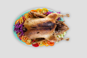 Top view of roasted chicken in plate with tomatoes