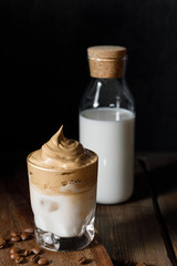 The Korean coffee drink dalgona on dark wooden background