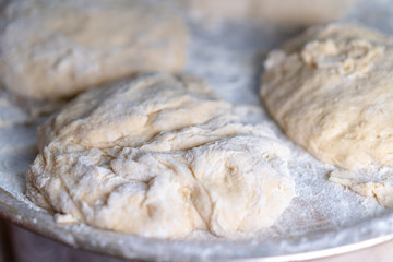 Flour dough sprinkled on a tray