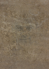 Face print on a rustly wall