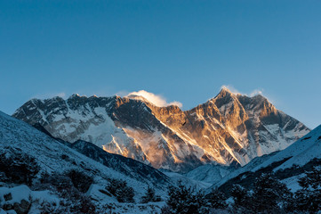 Sunrise on Nuptse, Lhotse and Mount Mt. Everest peaks with bird of prey at front. Trekking in Nepal...