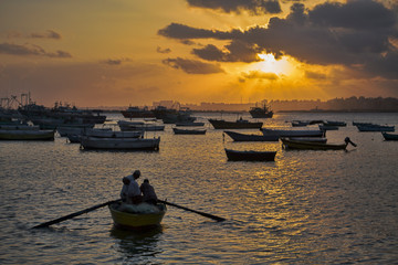 Silhouette of people in boat during sunset
