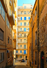 Obraz premium View of a narrow street with steps, old buildings and facades in the historical city of Agrigento in Sicily, Italy