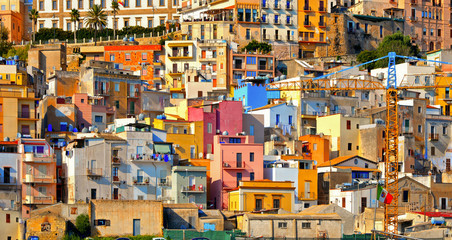 The colorful old houses with windows in city of Sciacca overlooking its harbour. Province of Agrigento, Sicily. - obrazy, fototapety, plakaty