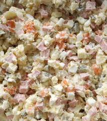 Olivier salad in a plate, top view.