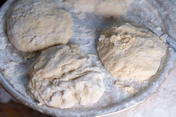 Flour dough sprinkled on a tray