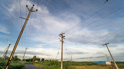 high voltage pillar power supply across a rural landscape during sunset