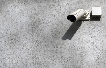 CCTV surveillance security camera video equipment in tower home and house building on wall for safety system area control outdoor with copyspace.CCTV Camera Operating on street.
