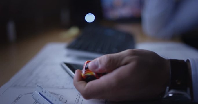 Man using fidget spinner while working
