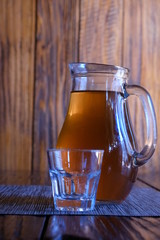 Georgian national cuisine. Georgian, home-made white dry wine - Rkatsiteli, in a jug. Drink on a wooden table.