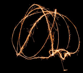 light painting with fireworks in isolated natural background. sparks are spreading