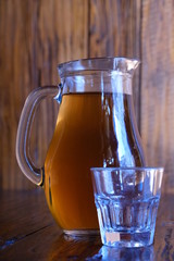 Georgian national cuisine. Georgian, home-made white dry wine - Rkatsiteli, in a jug. Drink on a wooden table.