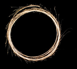 circle symbol by light painting with fireworks in isolated natural background. sparks are spreading