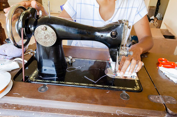 Seamstress Sewing With An Antique Machine