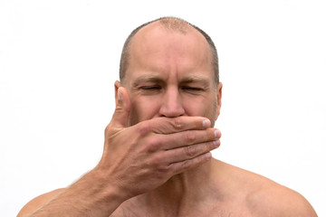 Close up portrait man covering mouth with his hand.