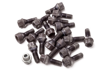 A handful of metal bolts with secret protection to fix the wheels and prevent theft of the car on a white background in photo studio. Spare consumables for replacing a wheel in a garage or car service