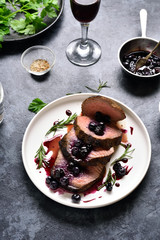 Sliced grilled beef with blueberry sauce