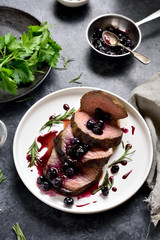 Sliced grilled beef with blueberry sauce
