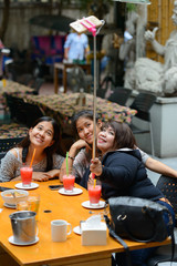 Group of young Asian women as friends taking selfie together outdoors