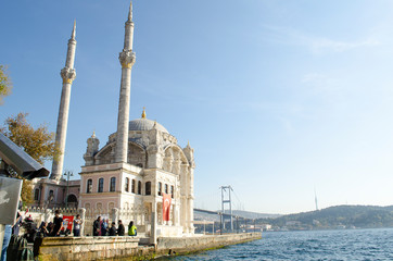 Fototapeta na wymiar Bosphorus Bridge and Ortakoy Mosque against blue sky, situated at the waterside of Ortakoy pier square, one of the most popular locations on Bosphorus. Turkey, Istanbul, Besiktas