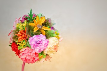 A round bouquet of different flowers on a neutral background. Place for text. Template for postcard, background, poster, site. Horizontal image format. High quality photo