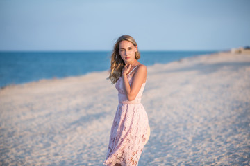 Fototapeta na wymiar young woman in white dress on the beach