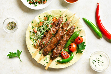 Adana Kebab with fresh vegetables on flatbread