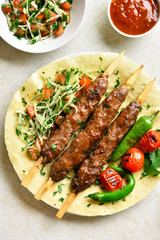 Adana Kebab with fresh vegetables on flatbread