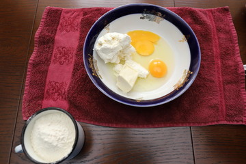 flour in a Cup, cottage cheese in a bowl, eggs, Saha and butter, cooking delicious pie at home, Easter on holiday, cooking yourself in the kitchen